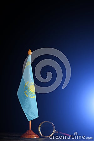 Flag Kazakhstan and magnifying glass on black background.Concept, under close attention Stock Photo