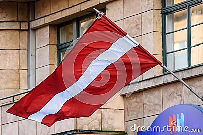 Flag of Latvia waves in Riga city Editorial Stock Photo