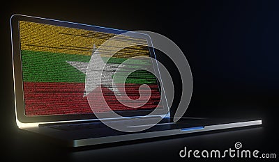 Open laptop and computer code on the screen composing flag of Myanmar. Modern information technology related 3d Stock Photo