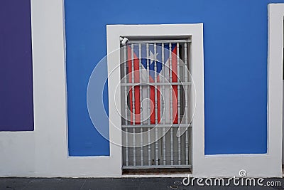 Flag of Puerto Rico behind bars Stock Photo