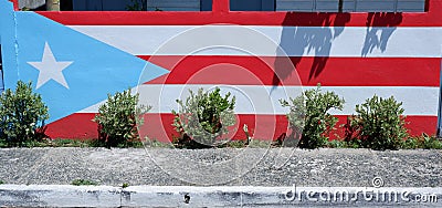 Flag of Puerto Ruco painted on wall next to the street Stock Photo