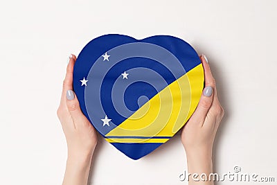 Flag of Tokelau on a heart shaped box in a female hands. White background Stock Photo