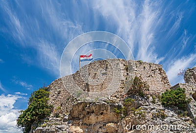 Flag on top of fortress above the Croatian town of Novigrad in Istria County Stock Photo
