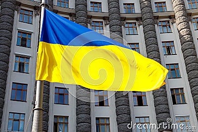 Flag of Ukraine against Cabinet of Ministers of Ukraine building Stock Photo