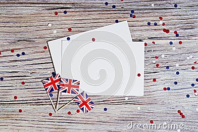 Flag of United Kingdom of Great Britain in hand on white wooden background top view. copy space. the concept of independence day, Stock Photo