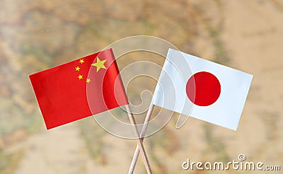 Flags of China and Japan over the world map, political relations concept image Stock Photo