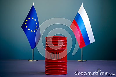 Flags of the EU and Russia and a barrel of oil as a symbol of sanctions. Stock Photo