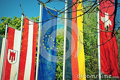Flags of German-speaking countries in front a park Stock Photo
