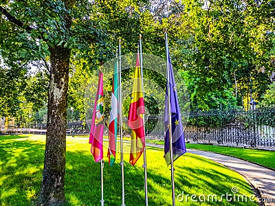 flags of Guernika, Euskadi, Spain and Europe next to the tree of Gernika, symbol of freedom Stock Photo