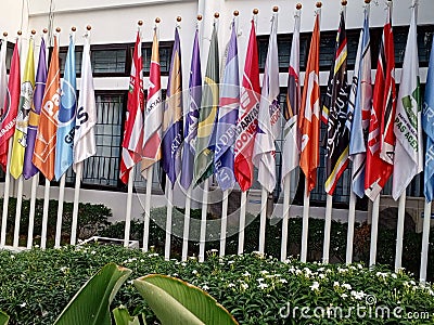 flags of political parties on their respective poles in front of the office of the independent election commission Editorial Stock Photo