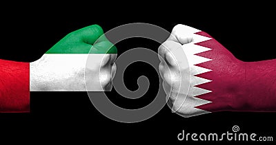 Flags of Qatar and Saudi Arabia painted on two clenched fists fa Stock Photo