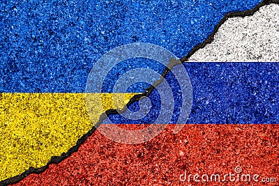 Flags of Russia and Ukraine painted on cracked wall background/Russia - Ukraine conflict concept Stock Photo