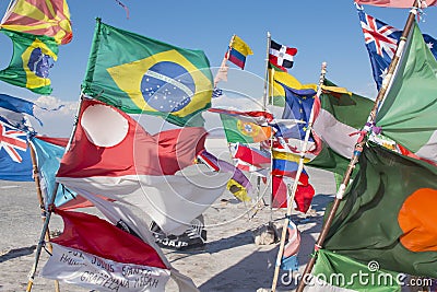 Flags in a salt desert of Salar de Uyuni in Bolivia Editorial Stock Photo