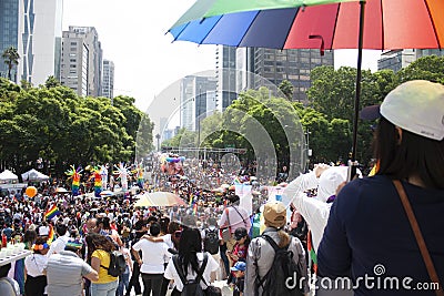 among flags, umbrellas and rainbow - coloured balloons the march with mines of people for LGBTTI pride in avenue of reform Editorial Stock Photo