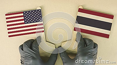 Flags of the USA and Thailand made of recycled paper on the cardboard table Stock Photo