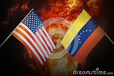 Flags of venezuela and United States of america against background of a fiery explosion. The concept of enmity and war Stock Photo