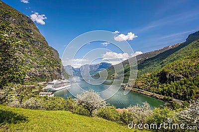 Flam village with ship in harbor against fjord during spring time, Norway Stock Photo