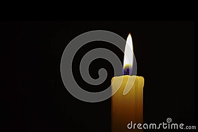 Flame of a candle in total darkness Stock Photo