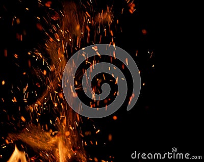 Flame of fire with sparks on a black background Stock Photo