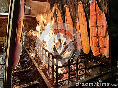 Flame grilled salmon, a traditional Nordic dish, at the Christmas market in Lindau, Germany. Stock Photo