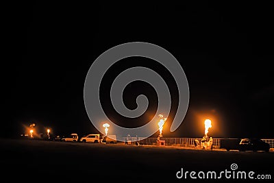 Flame rising from gas fire burners of hot air balloon in row at night Stock Photo