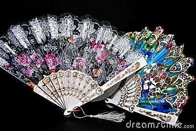 Flamenco hand fan with colorful pattern isolated on black background Stock Photo