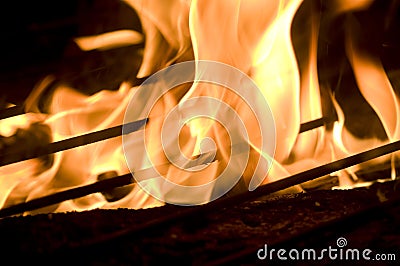 Flames blazing over wooden and grill Stock Photo