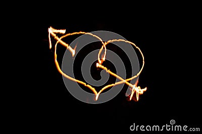 Flaming arrow pierced heart on black Stock Photo