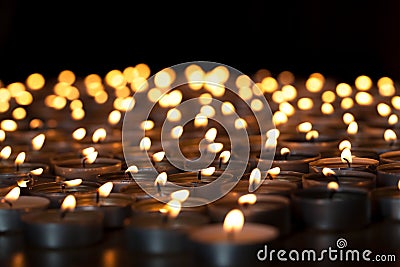Flaming candles. Spiritual image of tealights providing sacred l Stock Photo