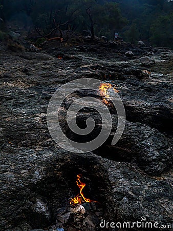 Flaming rock Yanartas, Chimera fires in eveninng, Antalya, Turkey Stock Photo