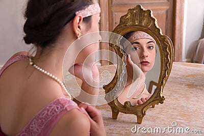 Flapper dress lady looking in mirror Stock Photo