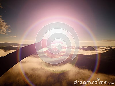 Flare. Lens defect, reflections. Open hand with long fingers touch Sun. Hilly landscape Stock Photo