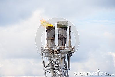 Flare stack of oil and gas platform to burn toxic gases and vent pressure from production process Stock Photo