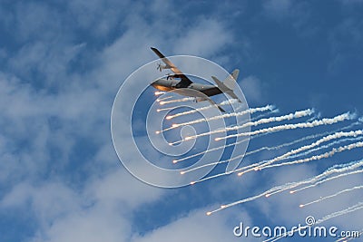 Hercules plane dropping flares Editorial Stock Photo