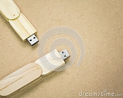 Flash drive on brown cardboard texture background. USB stick made from wood material concept Stock Photo