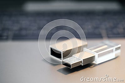 Flash drive. Stylish Steel glass card on the background of the keyboard Stock Photo