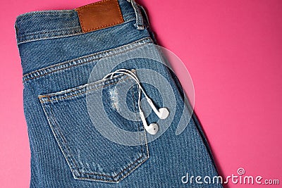 Flat background with copy space. Top view of casual woman outfit, jeans and headphones Stock Photo