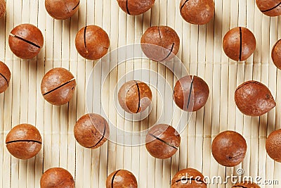Flat composition with Australian macadamia nuts on bamboo light background. Patterns, repetitions Stock Photo