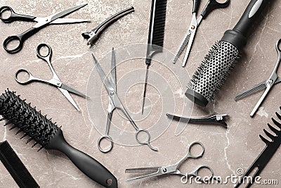 Flat composition with hairdresser`s accessories and scissors on brown marble Stock Photo