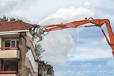 Flat is demolished with a grabber crane Stock Photo