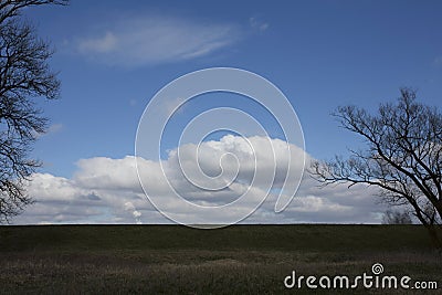 Flat horizon. Horizontal country landscape with sky, big clouds, grass and trees. Stock Photo