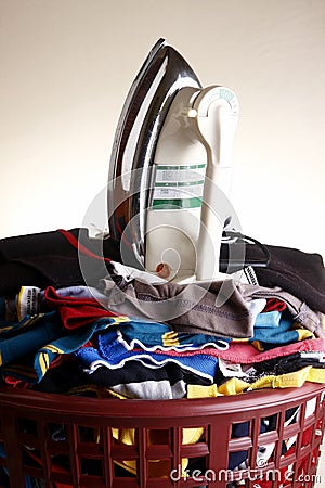 Flat iron on a pile of clothes Stock Photo