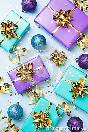 Flat lay background for celebration Christmas and New Year. Gift boxes are purple and turquoise with gold ribbons bows and Stock Photo