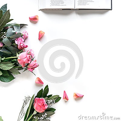 Flat lay: Bible and pink, red, rose flower bouquet. On white background Stock Photo