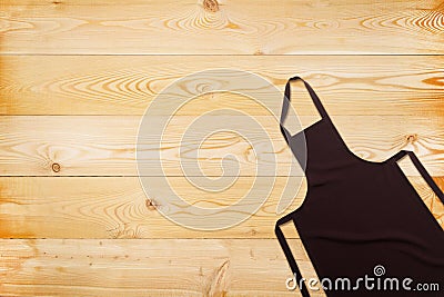 Flat lay of brown apron on wooden texture Stock Photo