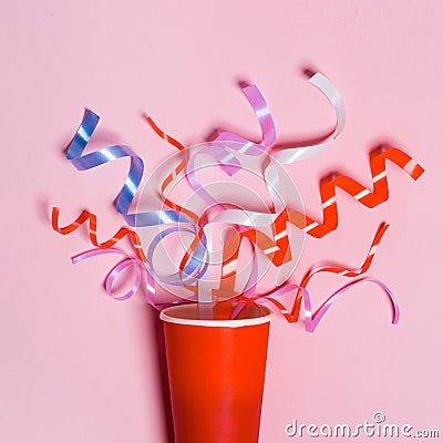 Flat lay of Celebration. Paper cup with colorful party streamers Stock Photo