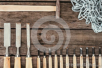 flat lay with chain hammer and chisels for woodcraft on dark Stock Photo