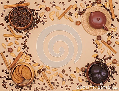 Flat lay coffee beans, teapot, oatmeal cookies and chocolate biscuit with spice on beige background Stock Photo