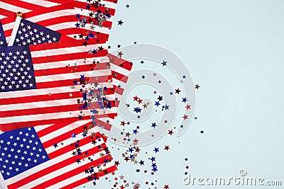 Flat lay composition with american flags and star shaped sparkles on light blue background. National symbolic of USA - flag Old Stock Photo