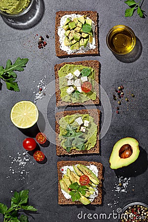 Flat lay composition of avocado toast on dark base. Vertical format Stock Photo